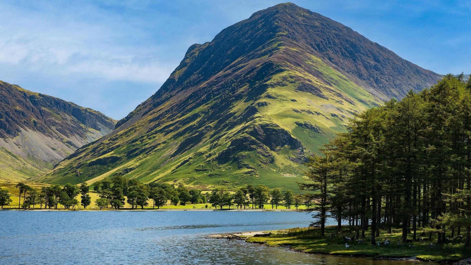 Calm waters of Buttermere with the tall mountain of Fleetwith Pike in the Lake District