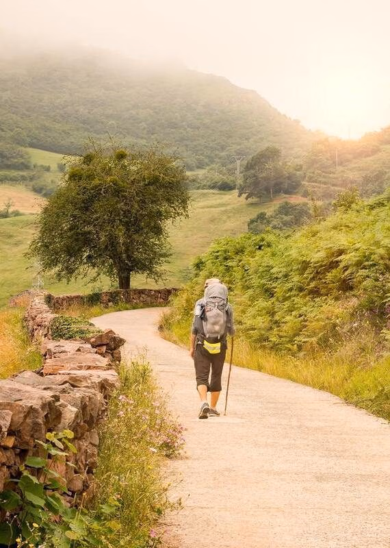 hiker with backpack walking the Camino de Santiago in Spain, Way of St James