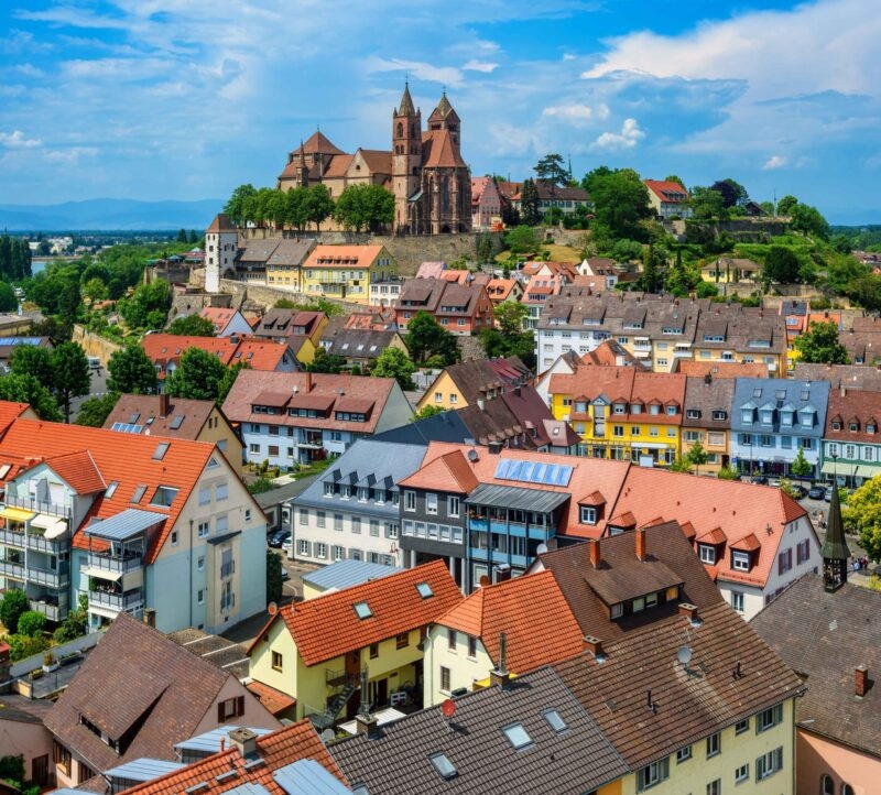 Colorful houses and the romanesque St Stephen's cathedral in the historical Old town of Breisach in the Rhine valley, Germany