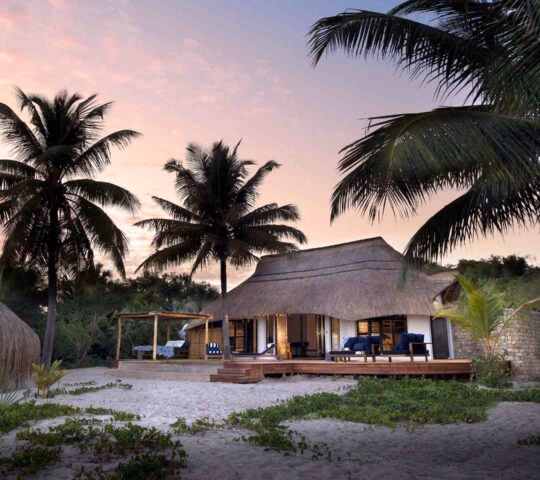 An external view of a casita or villa of andBeyond Benguerra Island at sunset.