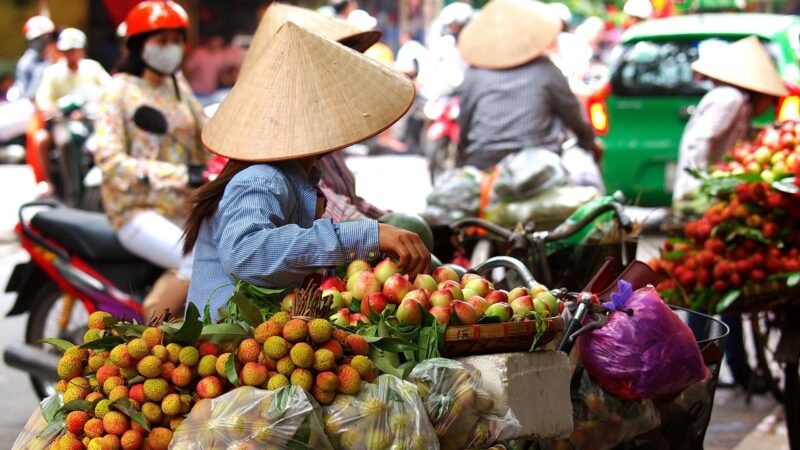 A street vendor with a cart of apples in Ho Chi Minh, Vietnam