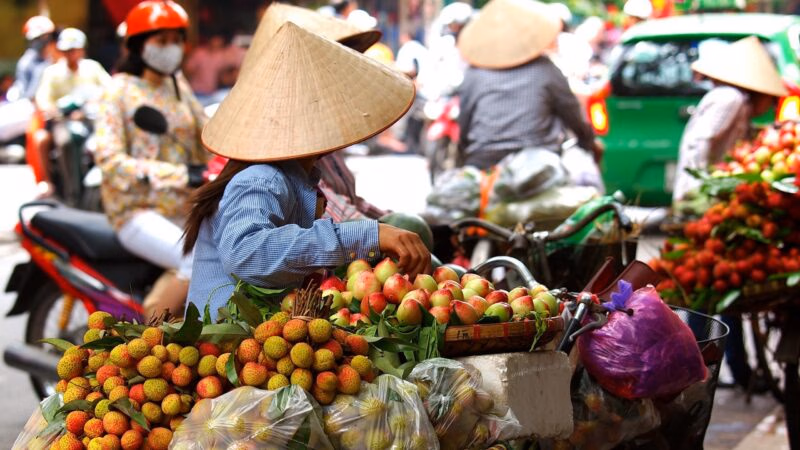 A street vendor with a cart of apples in Ho Chi Minh, Vietnam