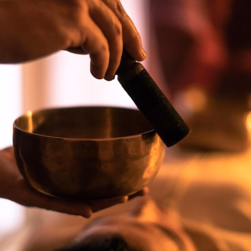 A sound bowl being used for a sound bath therapy
