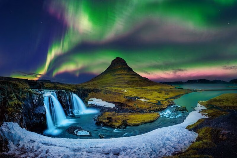 Northern lights tours - Northern Lights over a mountain in Iceland