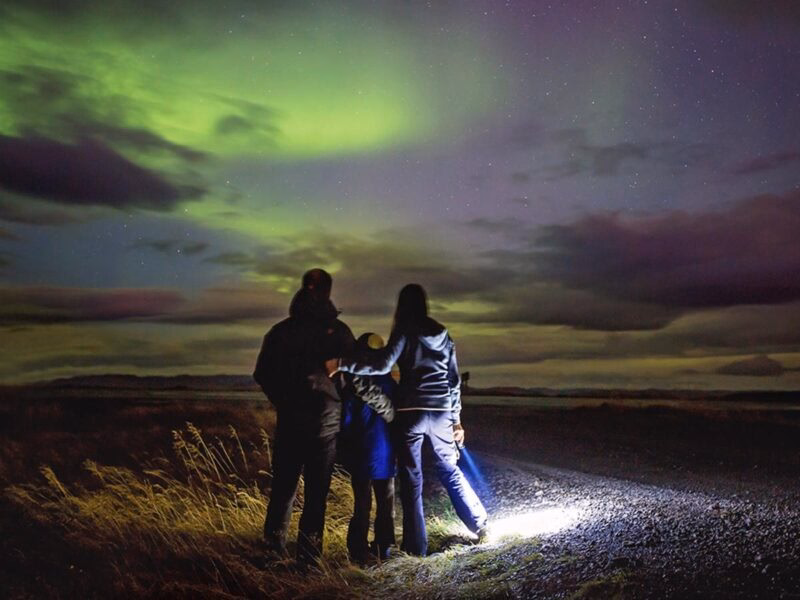 A family stood watching the northern lights