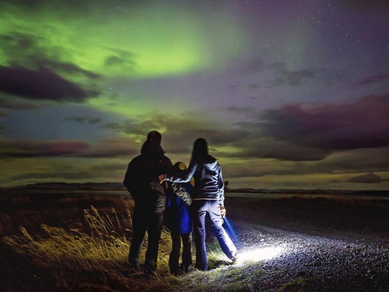 A family stood watching the northern lights