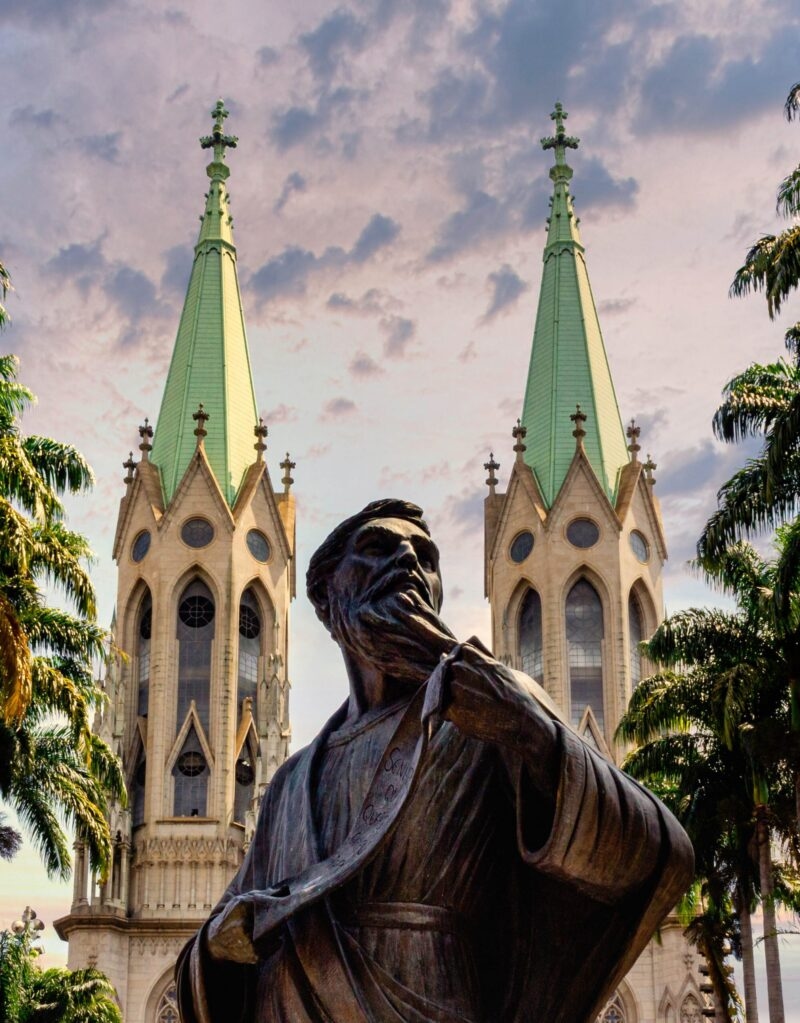 A statue with a cathedral in the background in Sao Paulo in Brazil.
