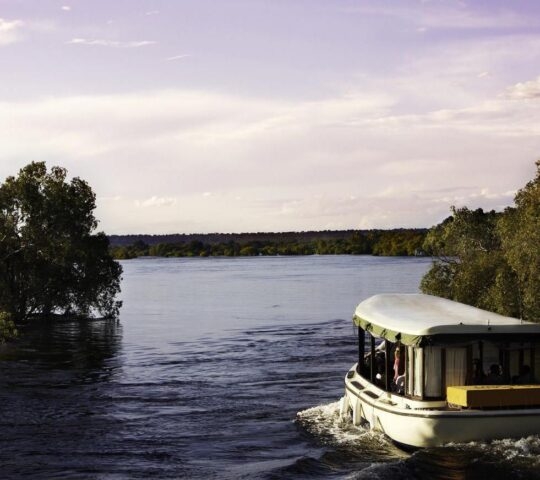 Boat on the Zambezi River at dusk.
