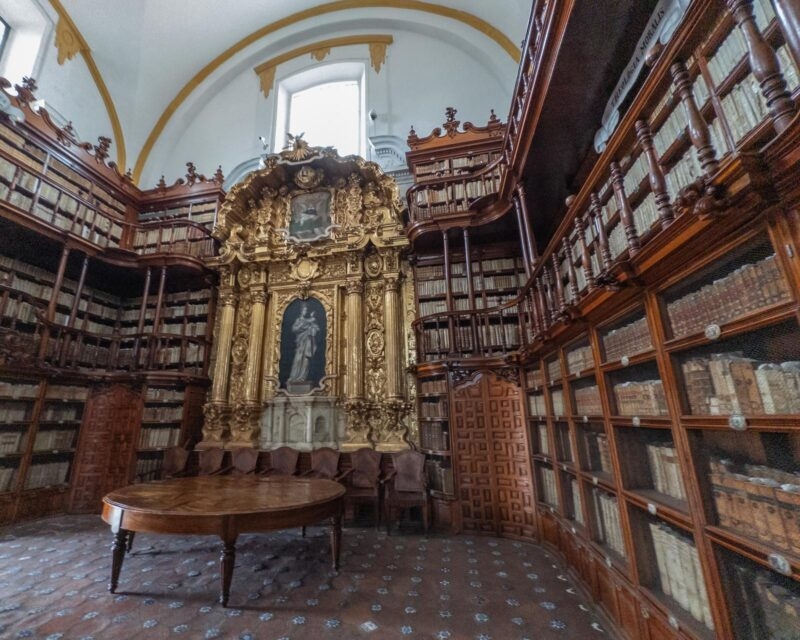 Historic Biblioteca Palafoxiana Library with Ornate Bookshelves in Puebla, Mexico