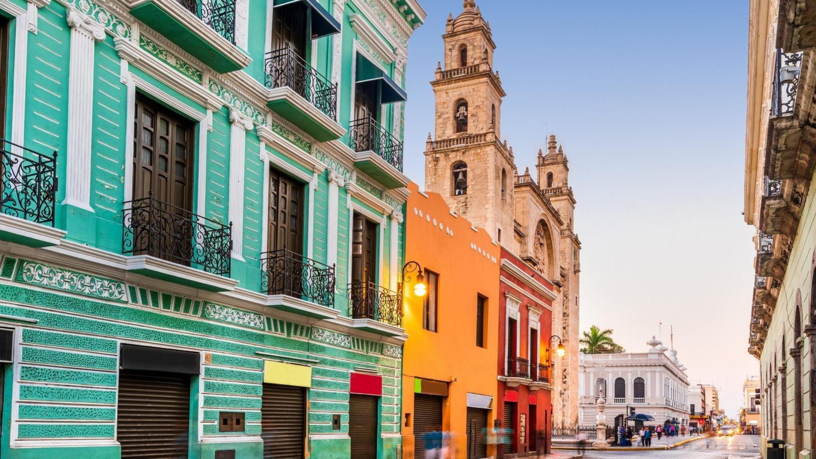 San Ildefonso cathedral seen behind colourful buildings in Mérida, Mexico