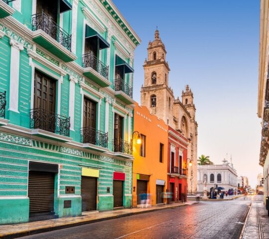San Ildefonso cathedral seen behind colourful buildings in Mérida, Mexico