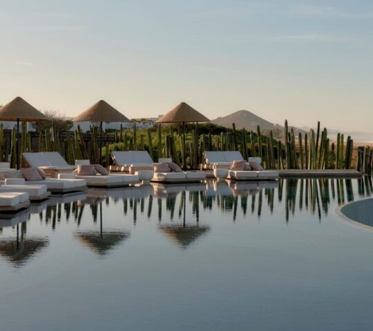 view of the pool with sun loungers round the edge at Kimpton Mas Olas, Baja California