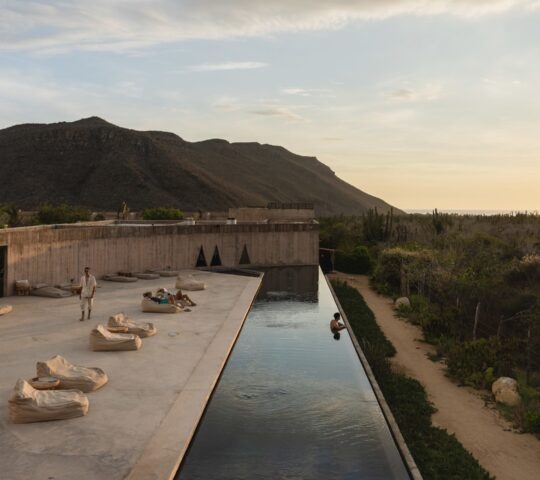 View of the outdoor pool with mountains in the background at Paradero in Todos Santos