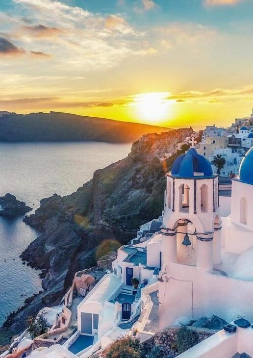 Sunset over Santorini cliffs, Udaipur City Palace in Rajasthan and Hohensalzburg Fortress in Salzburg.