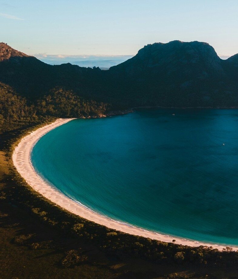 A view of Sydney Opera House, and Wineglass Bay in Tasmania