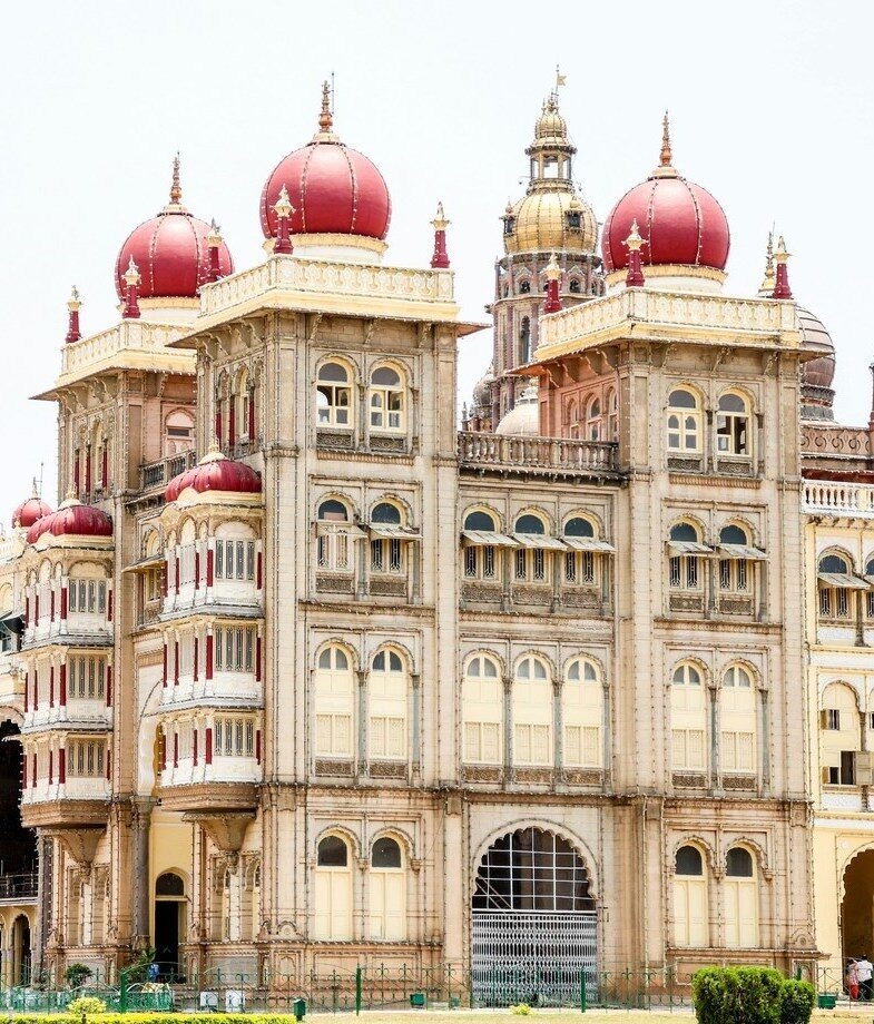 The imposing red sandstone of Agra Fort in Uttar Pradesh and the ornate domes of Mysore Palace.