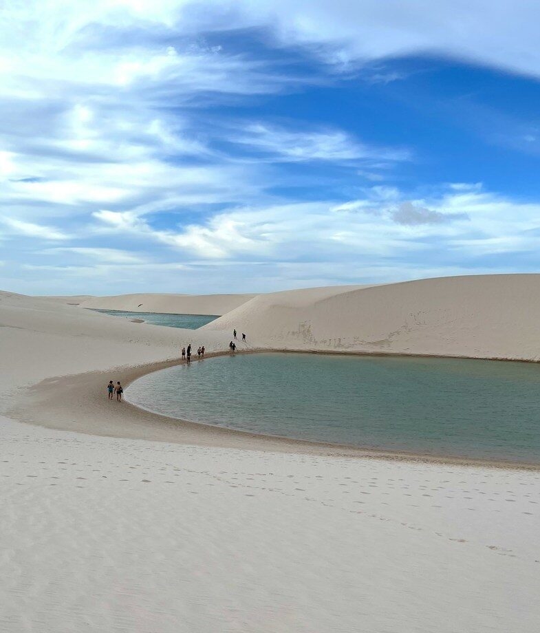 Aerial view of the Amazon Rainforest and the white sand dunes with shimmering pools of Lençóis Maranhenses National Park.
