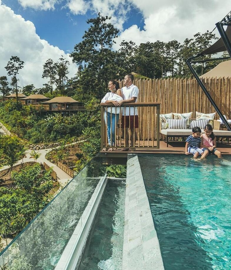 Sunlit living space with natural wood accents at Andaz Papagayo in Guanacaste Coast and a family enjoying a private pool at Nayara Tented Camp in Arenal.