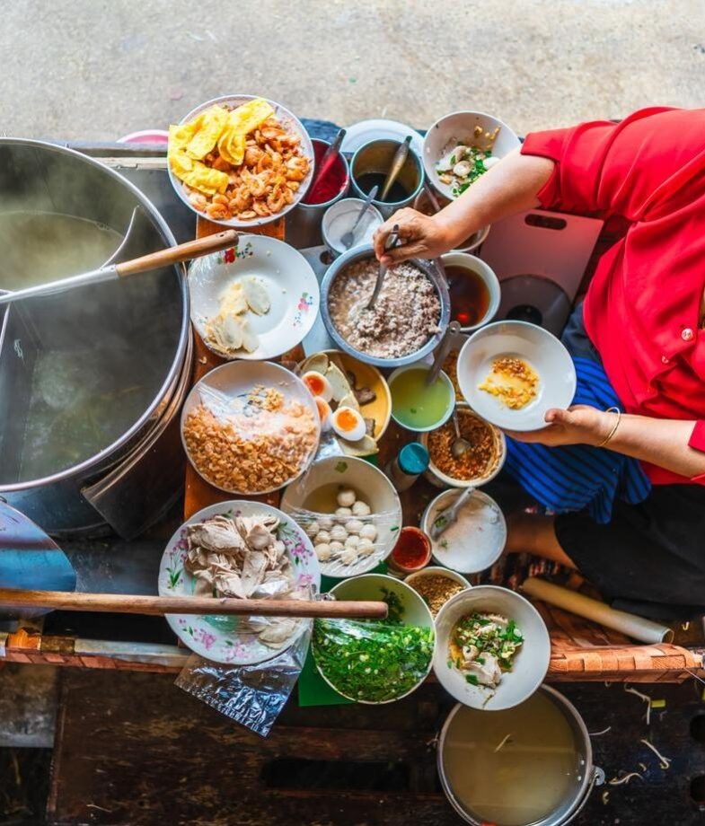 A woman cooking and selling street food in Vietnam, and a woman picking fresh tea leaves in Sri Lanka