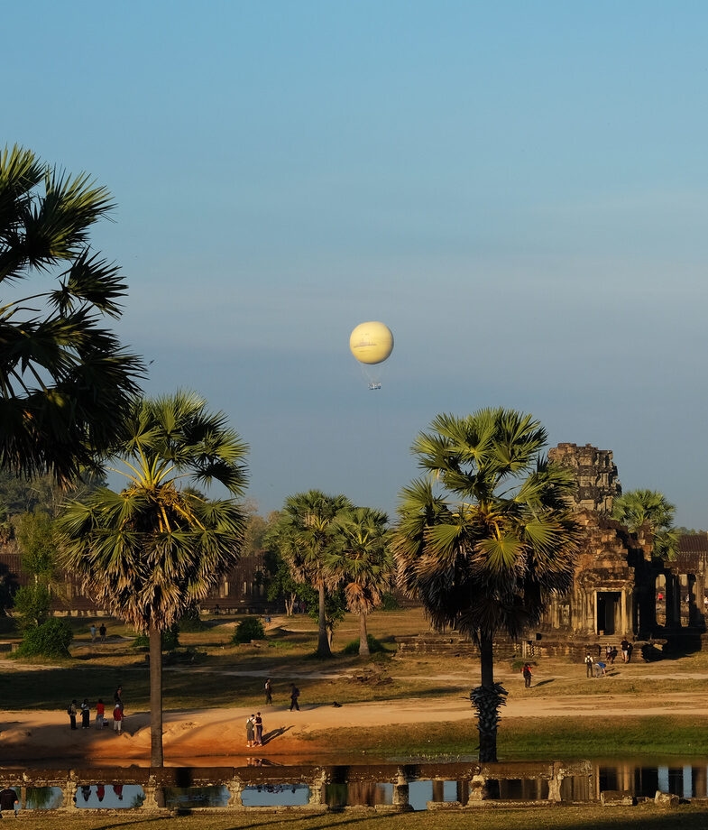 Looking out over Jaipur’s hillside fortresses and the ancient temple complex of Angkor Wat with a balloon drifting above.
