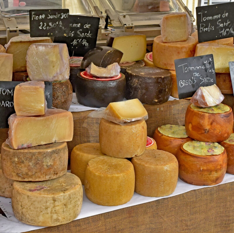 Variety of cheese displayed in an open air market, Ajaccio, Corsica