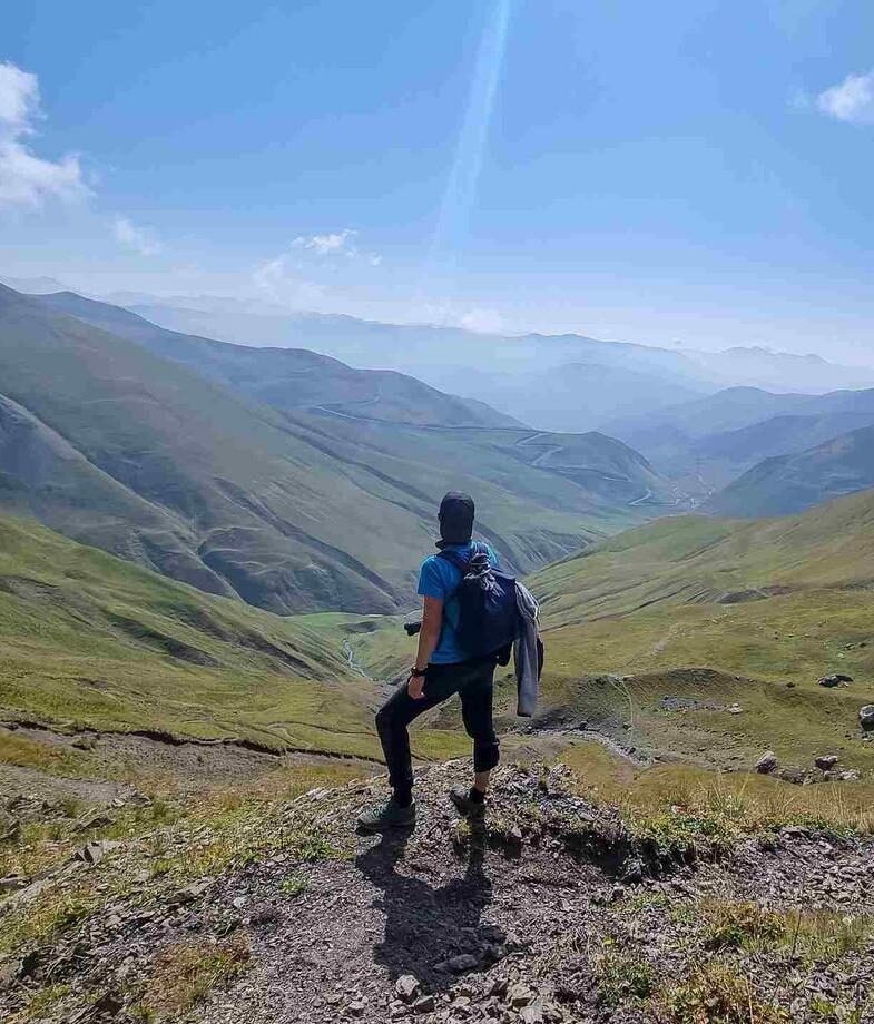A man watching the sharp mountain peaks of the Chaukhi