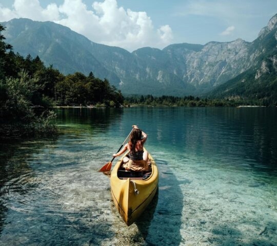 Kayaking on Lake Bohinj on emerald waters Slovenia