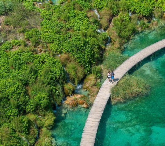 Aerial view of a wooden boardwalk leading through plitvice lakes national park in Croatia