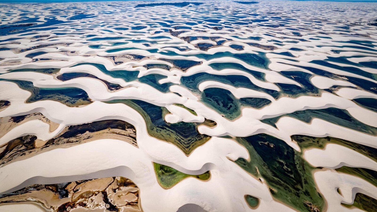 Aerial view of sand dunes and lagoons at Lençóis Maranhenses National Park