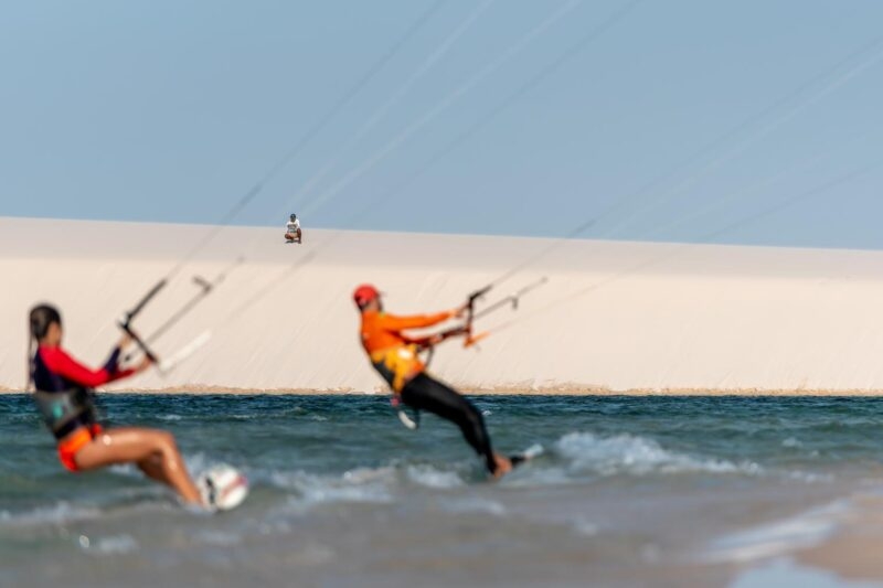 Two people kitesurfing on a lagoon at Lençóis Maranhenses