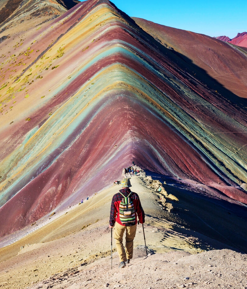 Mera Peak, a lesser-known summit within the Himalayas, and the striking colours of Vinicunca, or Rainbow Mountain, in the Peruvian Andes.