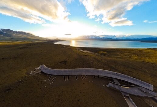 The sculpted timber form of Tierra Patagonia in Chile, the clifftop retreat of Alila Jabal Akhdar in Oman perched high above the canyon, and the serene reflection pools of Kempinski Hotel Ishtar Dead Sea in Jordan at sunset.