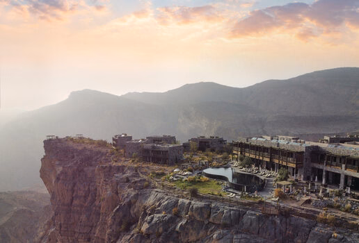 The sculpted timber form of Tierra Patagonia in Chile, the clifftop retreat of Alila Jabal Akhdar in Oman perched high above the canyon, and the serene reflection pools of Kempinski Hotel Ishtar Dead Sea in Jordan at sunset.