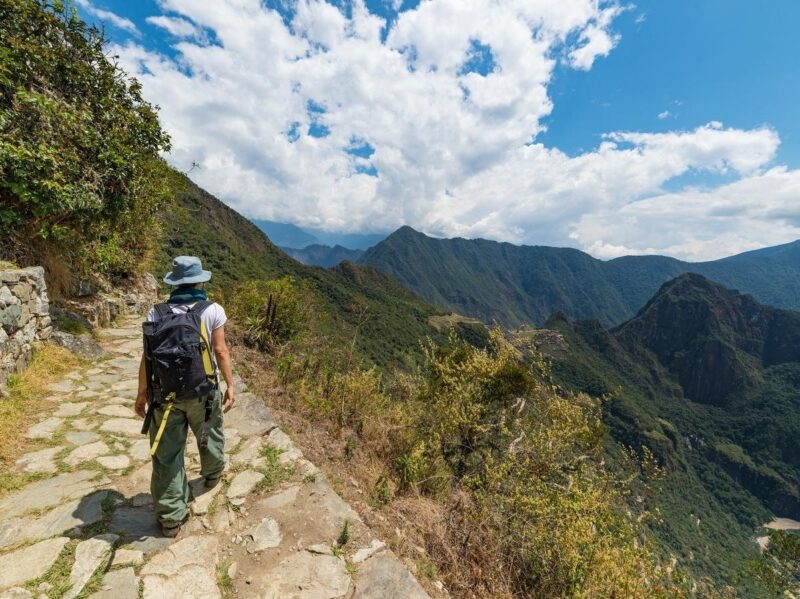 A person walking along a path on the edge of a cliff on the Inca Trsil