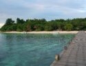 A wooden walkway over the sea leading to Lankayan Island in Borneo.