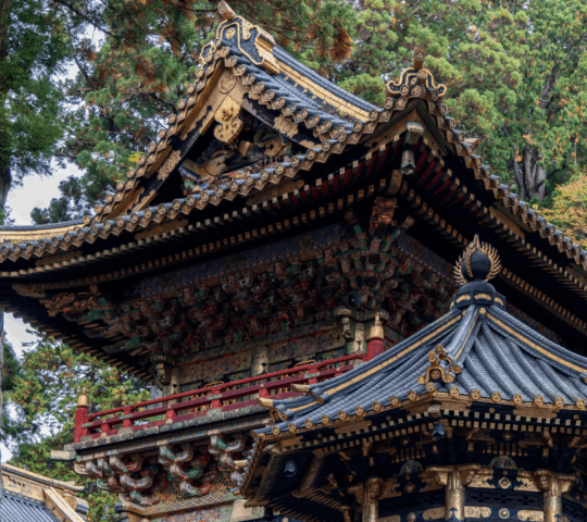 Historic Bell Tower at Toshogu Shrine in Nikko Japan with intricate architectural details golden ornaments and traditional wooden structures among lush green forest