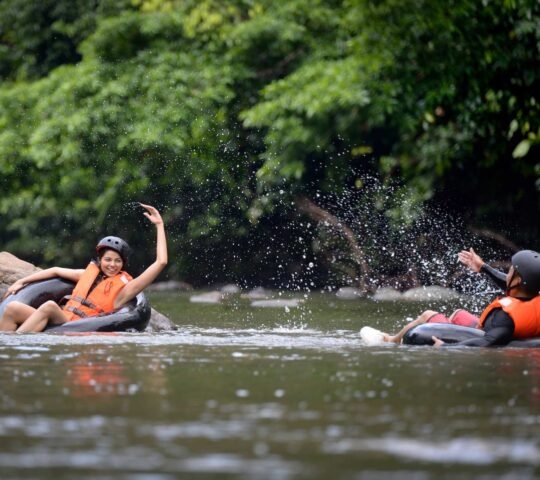 Two people tubing along the Danum River in Borneo's Danum Valley.