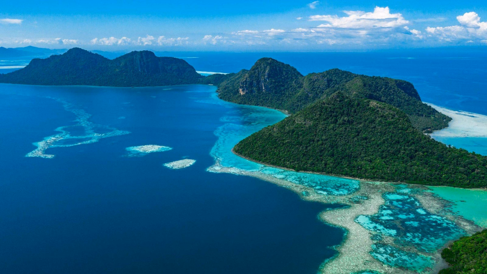 An aerial view of lush tropical islands in Borneo.