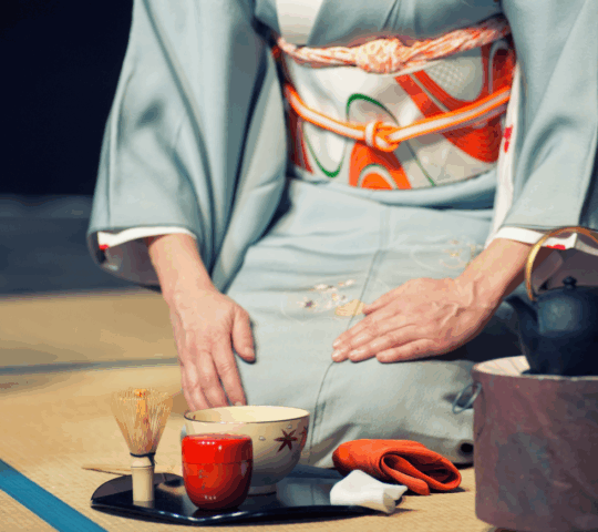 Woman prepares tea for a tea ceremony in Japan