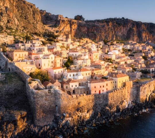 Houses in the walled town of Monemvasia glowing in the sunlight