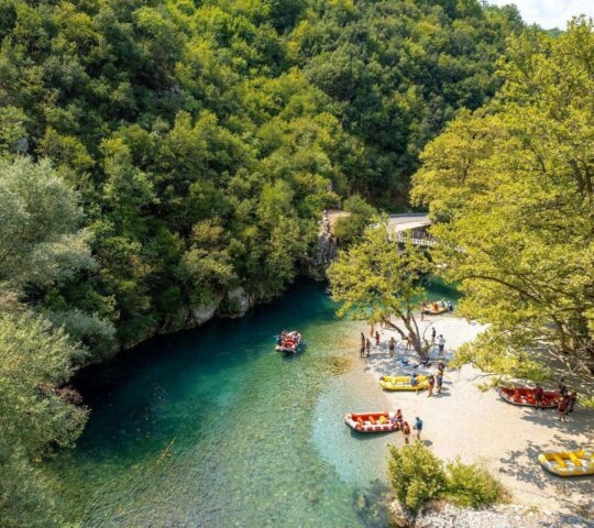aerial view of people in inflatable rafts on the Voidomatis river in Greece