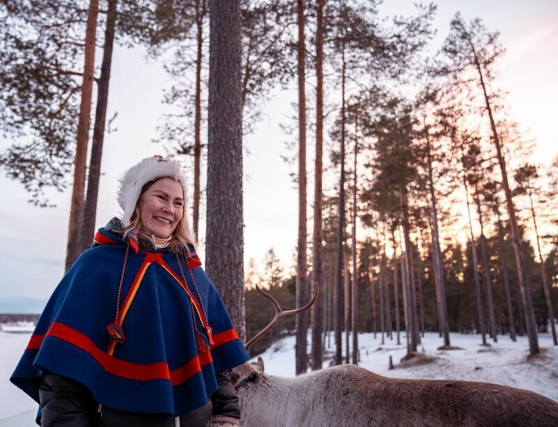 A member of the Sámi community captured smiling in snowy Northern Sweden.