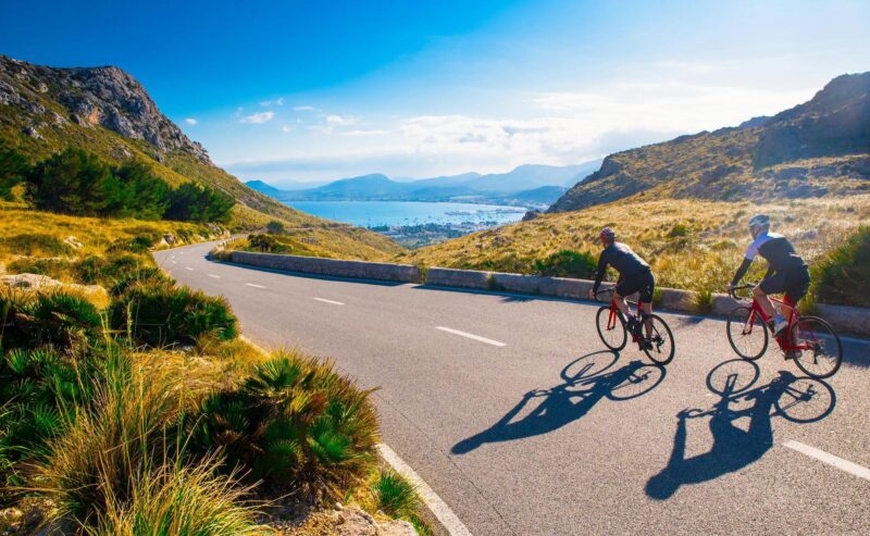Active day on bicycle on sunset along coast in Mallorca