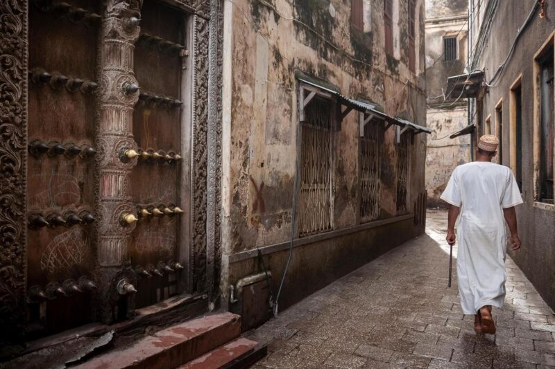 man walking through narrow streets of Stonetown