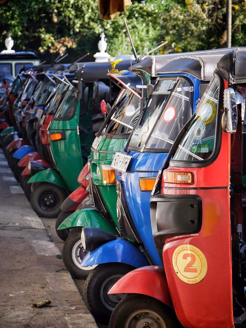 A colorful tuk-tuk navigating the historic streets of Kandy, offering a bespoke and authentic way to explore Sri Lanka’s cultural capital.
