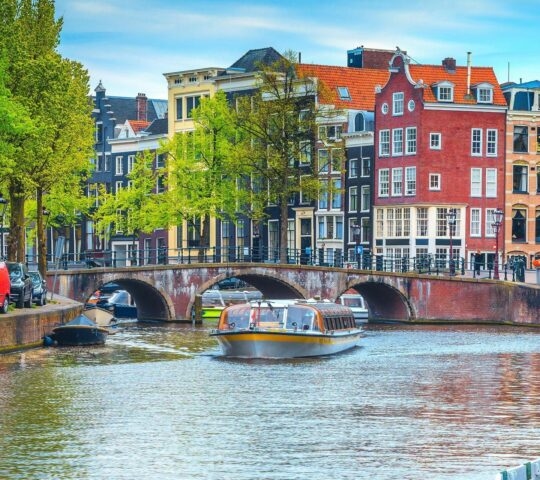 A boat cruise in Amsterdam along a canal.