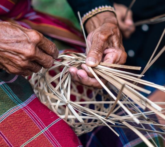 Close up man Hand weaving wicker basket