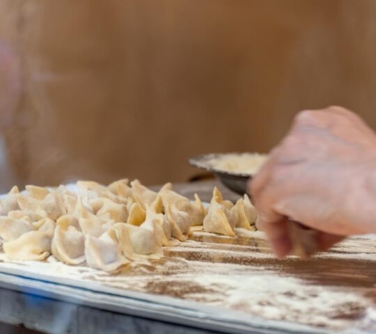 A person making pasta by hand.