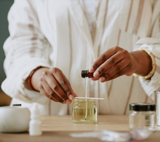 A person crafting perfume.