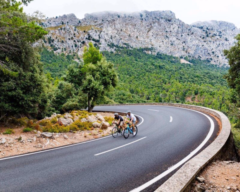 Two cyclists riding up the Puig Major peak in Majorca